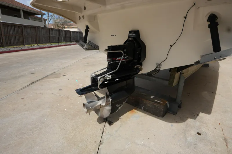 Slide: The Image of 2000 Sea Ray 270 Sundancer boat with Mercury outdrive, displayed on a concrete surface. - 6