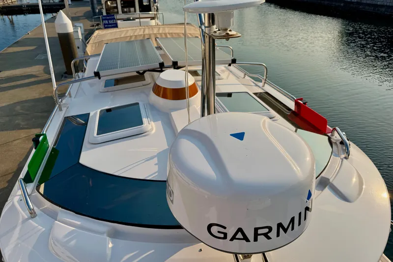 Slide: The Image of 2024 Ranger Tugs R-27 boat with Garmin equipment and solar panels docked at marina. - 20