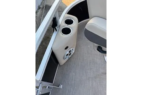 Slide: The Image of 2023 Sun Tracker Fishin' Barge 20 DLX interior with cup holders and speaker. - 10