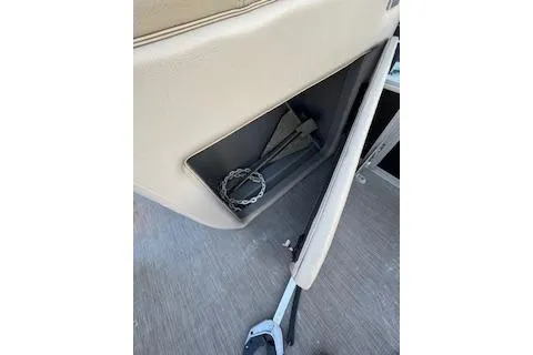 Slide: The Image of 2023 Sun Tracker Fishin' Barge 20 DLX storage compartment with anchor and chain. - 14