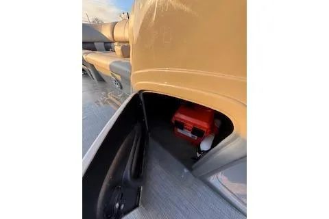 Slide: The Image of 2023 Sun Tracker Fishin' Barge 20 DLX storage compartment with red toolbox inside. - 15