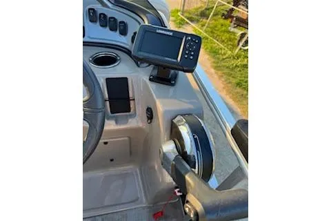 Slide: The Image of 2023 Sun Tracker Fishin' Barge 20 DLX dashboard with steering wheel and navigation system. - 17