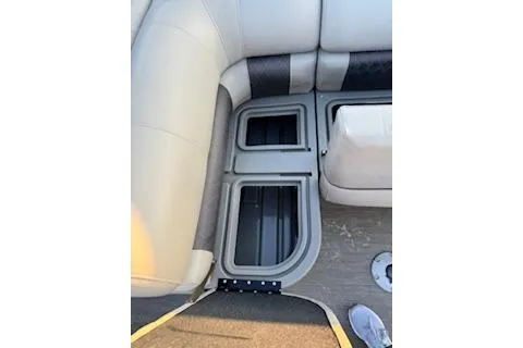 Slide: The Image of 2023 Sun Tracker Fishin' Barge 20 DLX interior seating and storage compartments. - 20