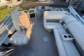 Slide: The Image of 2023 Sun Tracker Fishin' Barge 20 DLX interior with spacious seating and cup holders. - 23