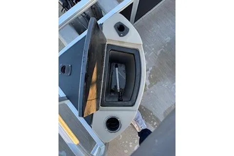 Slide: The Image of 2023 Sun Tracker Fishin' Barge 20 DLX console with storage compartment and cup holder. - 24