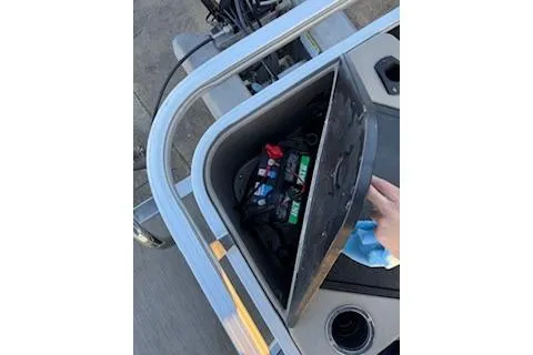 Slide: The Image of 2023 Sun Tracker Fishin' Barge 20 DLX battery compartment with open lid. - 25