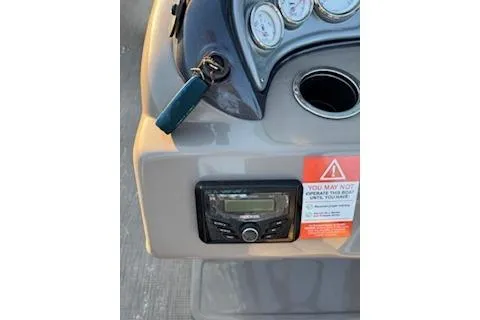 Slide: The Image of 2023 Sun Tracker Fishin' Barge 20 DLX dashboard with gauges and ignition key. - 27