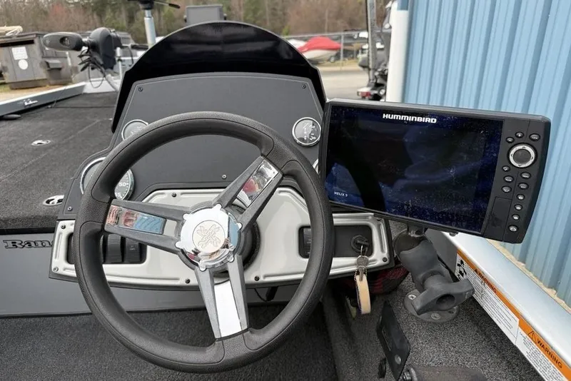 Slide: The Image of 2017 Ranger RT188 boat dashboard with steering wheel and Humminbird Helix 9 fish finder. - 10