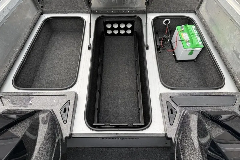 Slide: The Image of 2017 Ranger RT188 boat storage compartments with battery and carpeted interior. - 11