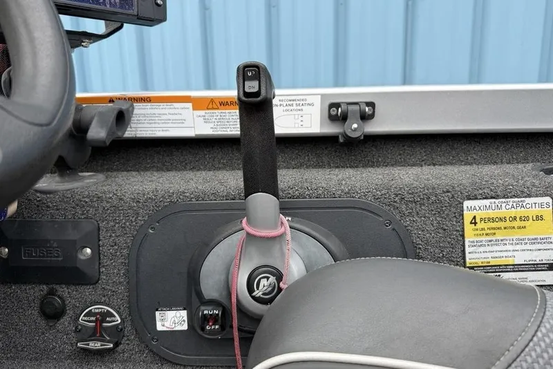 Slide: The Image of 2017 Ranger RT188 boat control panel with throttle and capacity warning labels. - 17