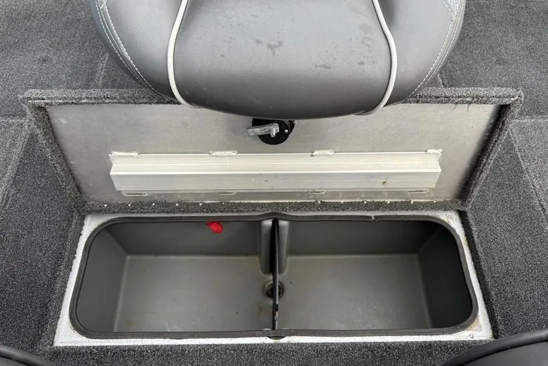 Slide: The Image of 2017 Ranger RT188 boat storage compartment with gray seat and carpeted interior. - 23