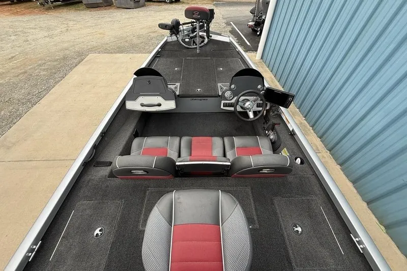 Slide: The Image of 2017 Ranger RT188 boat interior with red and gray seating, steering console, and carpeted deck. - 27