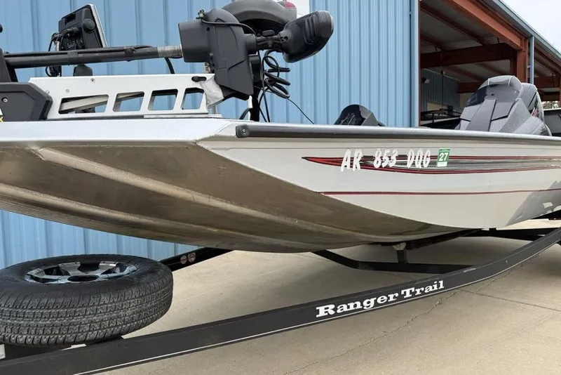 Slide: The Image of 2017 Ranger RT188 boat on trailer, parked near blue building. - 4