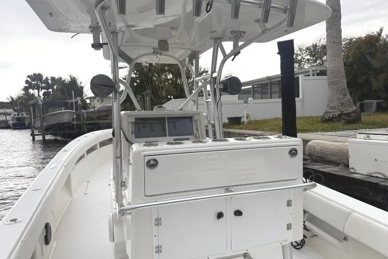Slide: The Image of 2008 SeaVee 320B boat with center console, docked near waterfront homes. - 10