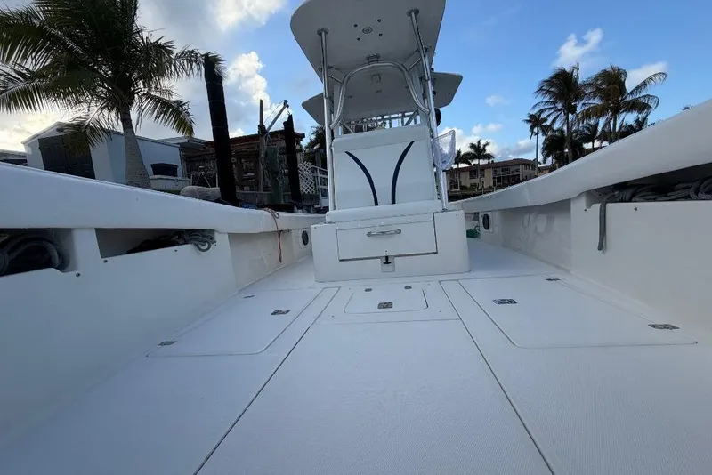 Slide: The Image of 2008 SeaVee 320B boat deck with center console, surrounded by palm trees and blue sky. - 15