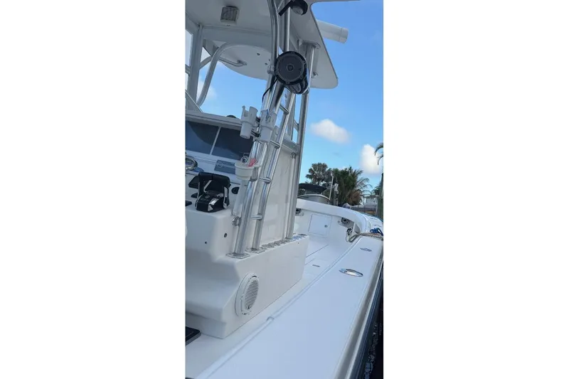 Slide: The Image of 2008 SeaVee 320B boat, white deck, clear sky, palm trees in background. - 16