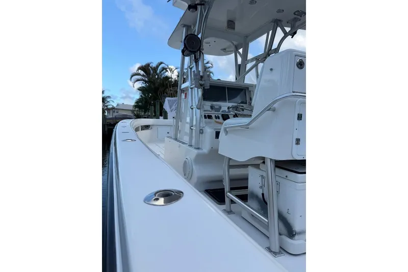 Slide: The Image of 2008 SeaVee 320B boat interior with helm, seating, and clear sky background. - 17