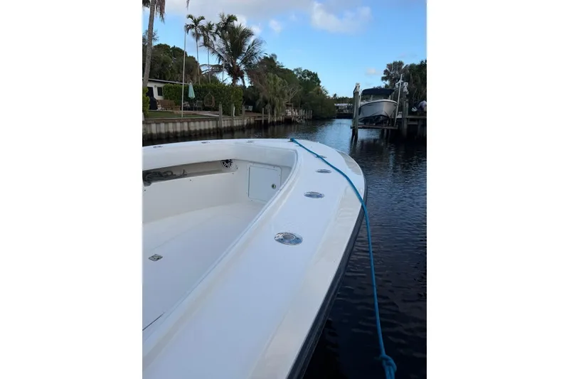 Slide: The Image of 2008 SeaVee 320B boat docked on a calm waterway with lush greenery. - 18