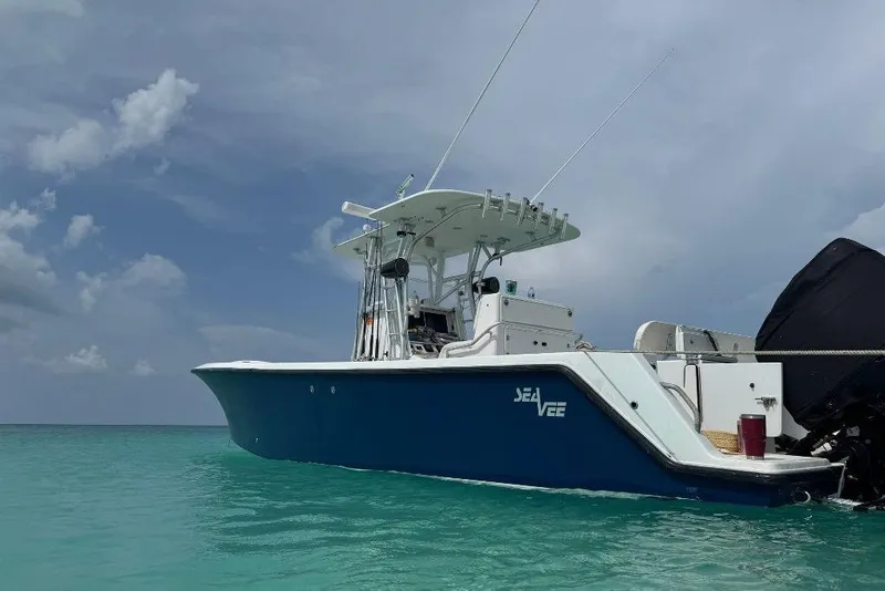 Slide: The Image of 2008 SeaVee 320B boat on clear turquoise water under a cloudy sky. - 2