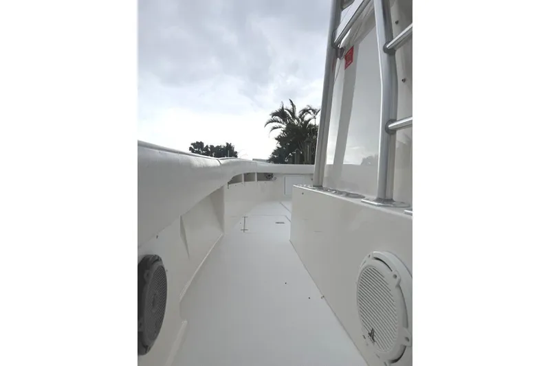 Slide: The Image of 2008 SeaVee 320B boat deck with railing and speaker, under cloudy sky. - 21