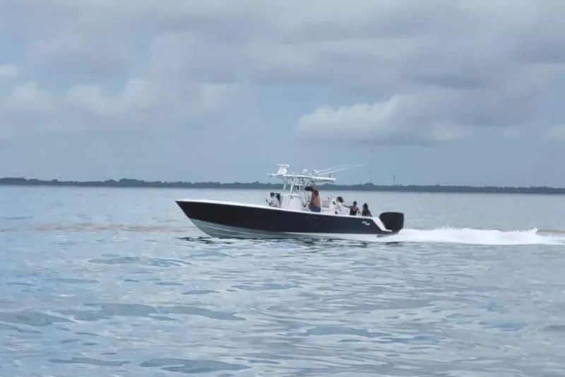 Slide: The Image of 2008 SeaVee 320B boat cruising on calm waters under cloudy skies. - 3