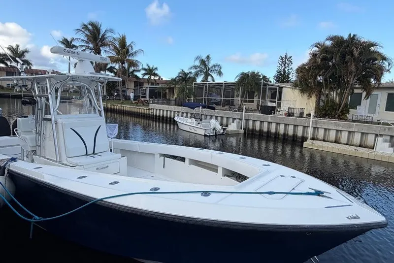 Slide: The Image of 2008 SeaVee 320B boat docked in a scenic canal with palm trees. - 5