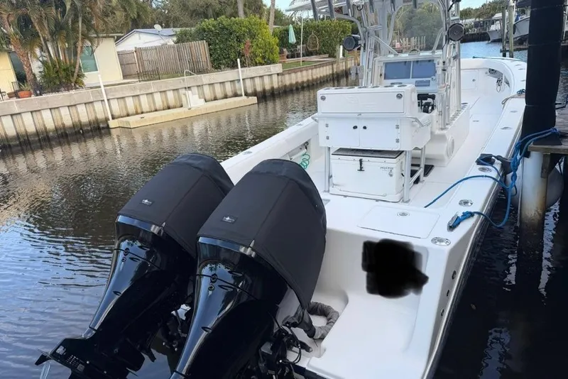 Slide: The Image of 2008 SeaVee 320B boat docked with dual outboard engines in a canal setting. - 6