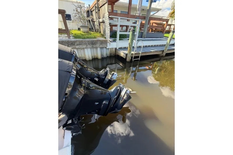 Slide: The Image of 2008 SeaVee 320B boat engines docked by a wooden pier. - 7