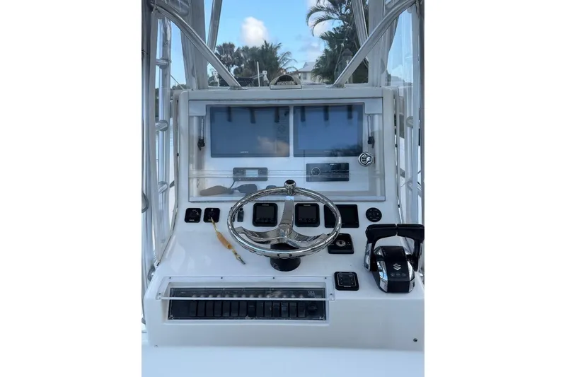 Slide: The Image of 2008 SeaVee 320B boat dashboard with steering wheel and navigation controls. - 8