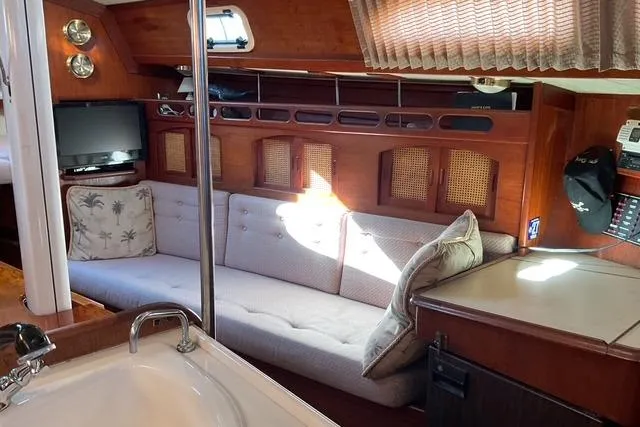 Slide: The Image of Cozy interior of a 1990 Ericson 34 sailboat with a comfortable seating area. - 14