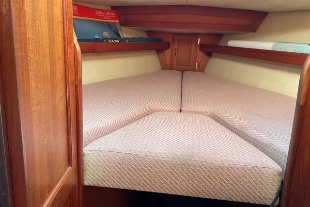 Slide: The Image of Cozy cabin interior of a 1990 Ericson 34 sailboat with cushioned V-berth. - 15