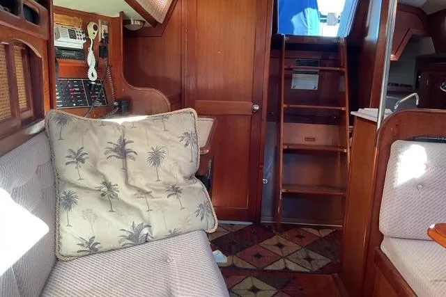 Slide: The Image of Interior of a 1990 Ericson 34 sailboat with wooden finishes and nautical decor. - 16