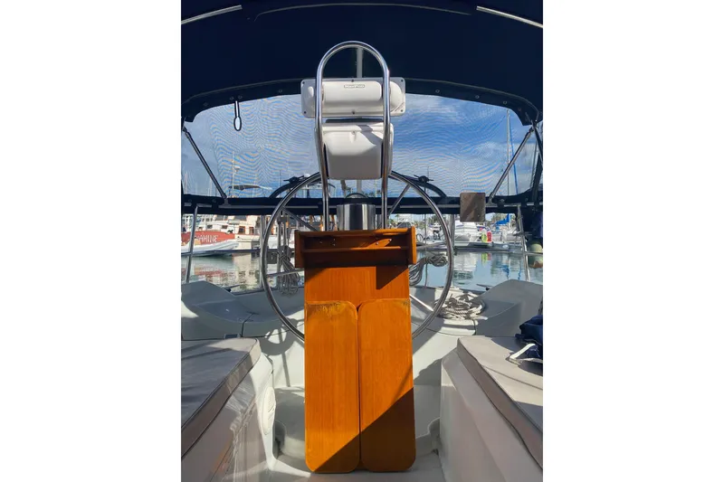 Slide: The Image of Cockpit of a 1990 Ericson 34 sailboat with steering wheel and wooden console. - 5