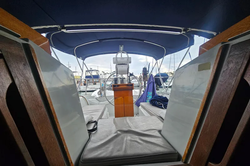 Slide: The Image of Interior view of a 1990 Ericson 34 sailboat cockpit with blue canopy. - 8