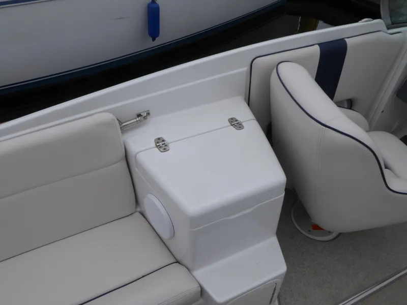 Slide: The Image of Interior of a 2004 Chris-Craft Corsair 25 boat with white seating. - 11