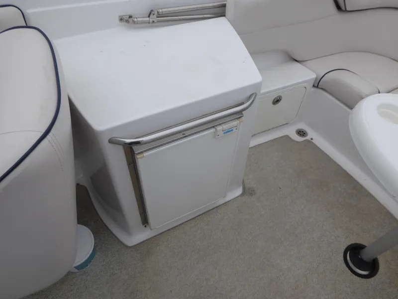 Slide: The Image of Interior of a 2004 Chris-Craft Corsair 25 boat with refrigerator. - 12