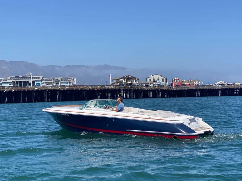 Slide: The Image of 2004 Chris-Craft Corsair 25 boat on water near a pier. - 22