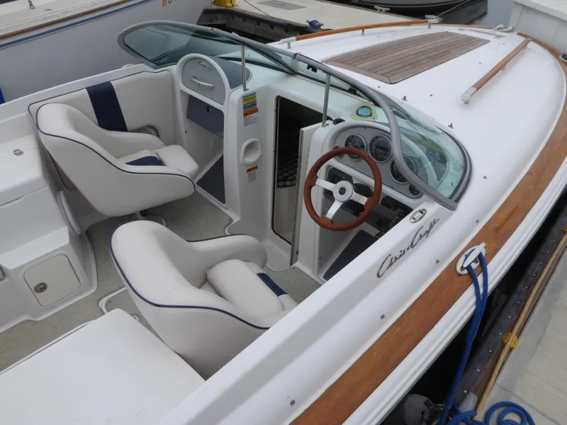 Slide: The Image of 2004 Chris-Craft Corsair 25 boat with luxurious interior and wood accents. - 4