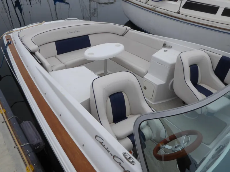 Slide: The Image of Interior of a 2004 Chris-Craft Corsair 25 boat with white seating. - 5