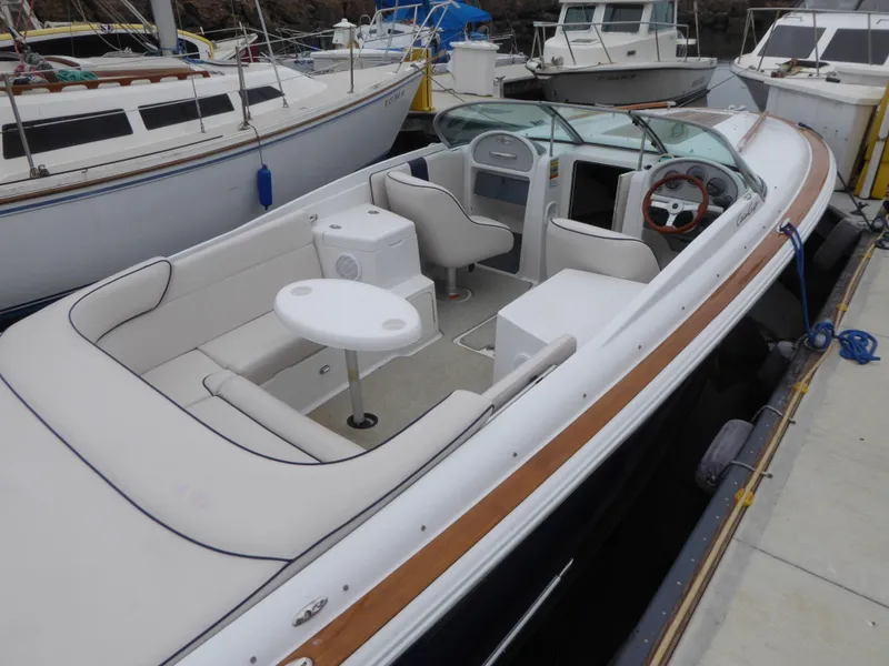 Slide: The Image of 2004 Chris-Craft Corsair 25 boat docked, featuring sleek design. - 6