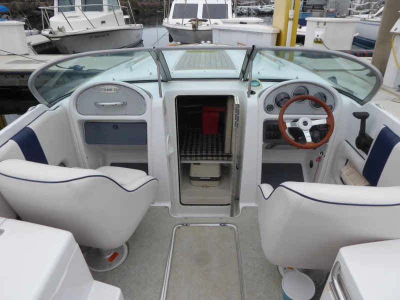 Slide: The Image of Interior of a 2004 Chris-Craft Corsair 25 with helm and seating. - 9