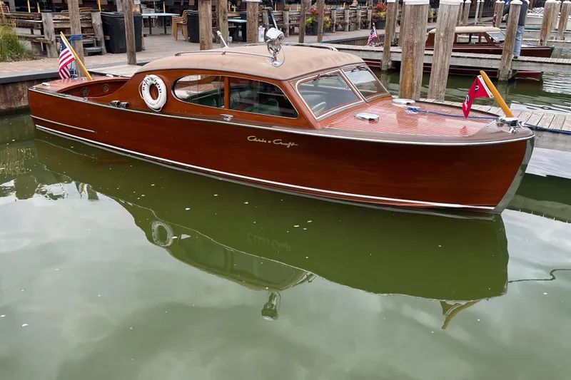 The Image of 1948 Chris-Craft 24 Sportsman wooden boat docked in calm waters. - 1