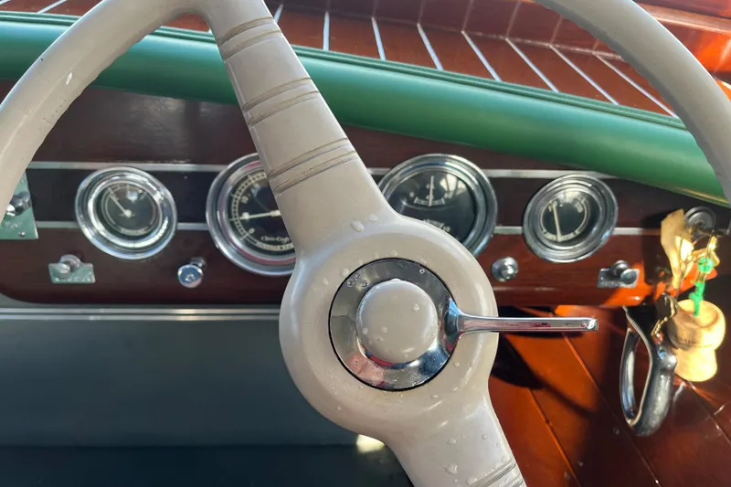 Slide: The Image of 1948 Chris-Craft 24 Sportsman dashboard with vintage steering wheel and gauges. - 12