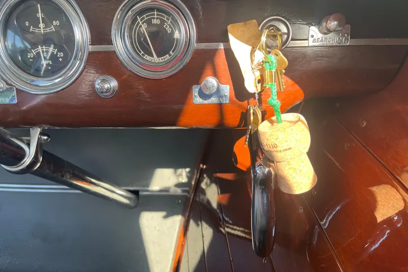 Slide: The Image of 1948 Chris-Craft 24 Sportsman dashboard with vintage gauges and keys. - 16