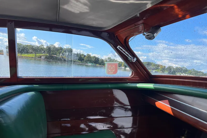 Slide: The Image of Interior view of a 1948 Chris-Craft 24 Sportsman boat with lake scenery outside. - 7