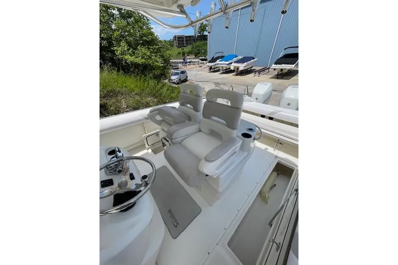 Slide: The Image of 2008 Boston Whaler 320 Outrage boat interior with dual captain's chairs and steering console. - 10