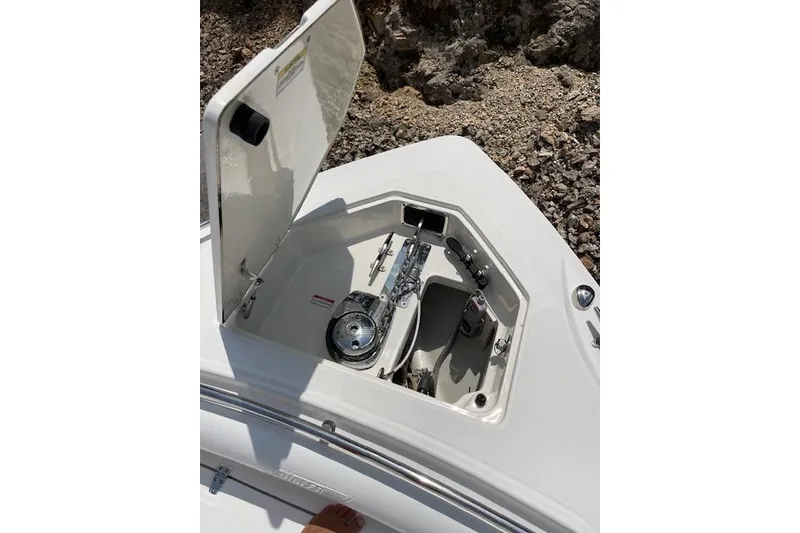 Slide: The Image of Open anchor compartment on 2008 Boston Whaler 320 Outrage boat, showing anchor mechanism. - 16