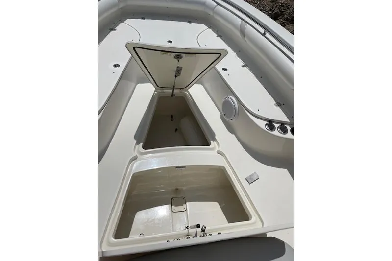 Slide: The Image of 2008 Boston Whaler 320 Outrage boat interior with open storage compartments. - 19