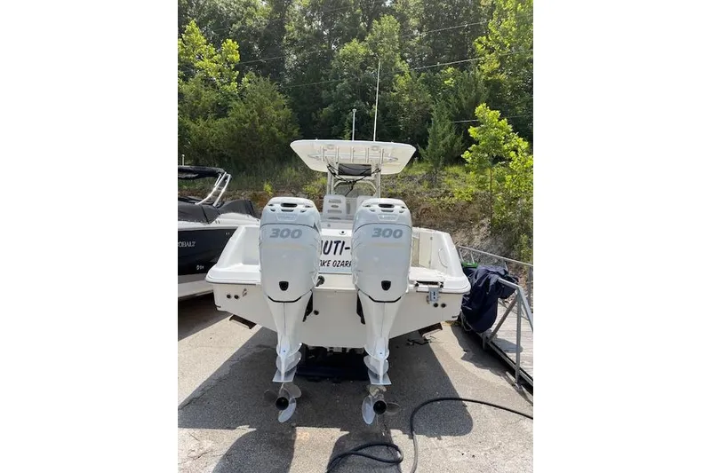 Slide: The Image of 2008 Boston Whaler 320 Outrage with twin 300 horsepower engines, parked outdoors. - 2