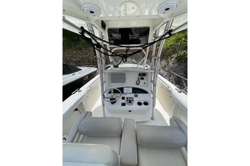 Slide: The Image of 2008 Boston Whaler 320 Outrage boat cockpit with steering wheel and controls. - 7